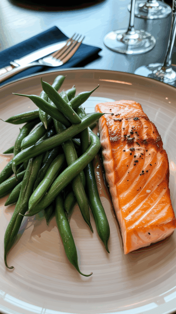 A plated meal of pan-seared salmon served with the Green Bean Salad.