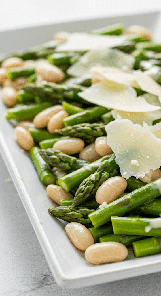 A platter of homemade, warm Parmesan Asparagus and Butter Bean Salad.