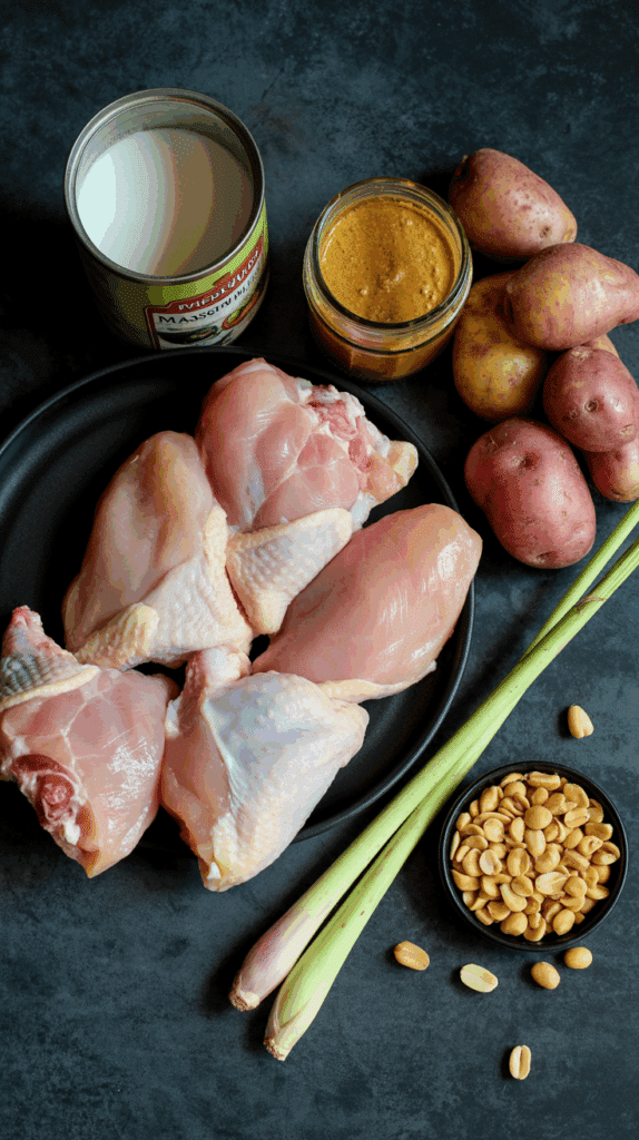 The fresh ingredients for the Slow-Cooker Chicken Curry, including chicken thighs, coconut milk, and Massaman paste.