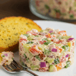 A plated serving of the finished Tuna Salad with a piece of herb toast.