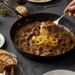 Serving the classic Beef Stroganoff at an elegant, cozy dinner party.