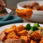 Two beautiful, homemade Chili Stuffed Sweet Potatoes on a dinner plate, being served for a family dinner.