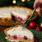 A beautiful, layered slice of homemade Cranberry Custard Pie being served as dessert at a festive holiday dinner.