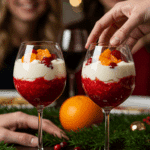Two beautiful, homemade Cranberry Orange Parfaits being served at a festive holiday party.