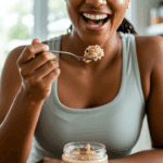 A happy person eating a jar of healthy, high-protein cookie dough as a post-workout snack.