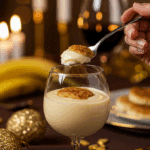 An elegant glass of homemade Banana Pudding being served as dessert at a festive dinner party.