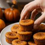 A platter of beautiful, homemade Sweet Potato-Marshmallow Mini Cupcakes being served at a festive holiday party.