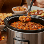 A slow cooker filled with homemade Turkey Sweet Potato Chili being served at a fun fall party.