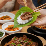 The finished bowl of homemade Beef Bulgogi being served and made into a "ssam" lettuce wrap at a fun and casual Korean BBQ dinner.