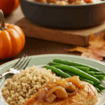 A healthy dinner plate with a serving of homemade, saucy Autumn Harvest Chicken, served with quinoa and green beans for a cozy meal.