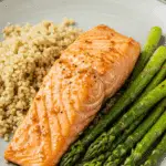 A beautiful and healthy dinner plate of homemade Brown Sugar-Glazed Salmon served with fluffy quinoa and roasted asparagus.