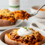 A beautiful bowl of a homemade, healthy Chili Cheese Stuffed Sweet Potato being enjoyed for a vibrant and healthy lunch.
