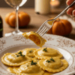 An elegant plate of homemade, creamy Butternut Squash Ravioli being enjoyed for a sophisticated and cozy, candlelit fall dinner.