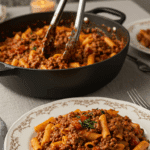 A large bowl of homemade, creamy Weeknight Bolognese being served at a cozy family dinner.