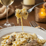 An elegant plate of homemade, creamy Garlic Parmesan Chicken Pasta being enjoyed for a sophisticated and romantic, candlelit dinner.