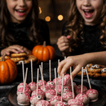 A large platter of homemade, spooky, and colorful Cake Pop Brains being served at a fun and casual Halloween party.