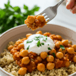 A beautiful bowl of homemade, healthy Lemony Chickpeas being served over a bed of quinoa for a delicious weeknight dinner.