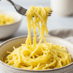 A beautiful bowl of homemade, creamy Spaghetti Squash Alfredo being served for a healthy dinner.