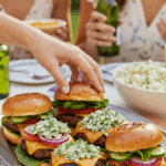 A large platter of homemade, juicy Burgers with Spicy Dill Salsa being served at a fun summer barbecue.