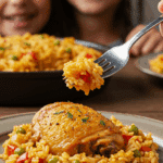 A hearty plate of homemade, authentic Arroz con Pollo being served for a casual family dinner.