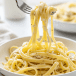 An elegant plate of homemade, creamy Cauliflower Chicken Alfredo being enjoyed for a healthy and satisfying weeknight dinner.