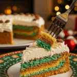 A beautiful plate with a homemade, festive, and layered slice of an Italian Rainbow Cookie Cake being served for a holiday dessert.