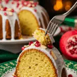 A beautiful plate with a homemade, festive, and moist slice of a 'Jingle Bell' Bundt Cake being served for a holiday dessert.