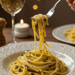 An elegant plate of homemade, creamy Spaghetti Aglio e Olio being enjoyed for a sophisticated and romantic, candlelit dinner.