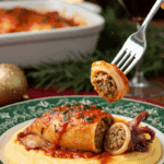 A festive plate of a homemade, elegant, and saucy Stuffed Calamari, being served over creamy polenta at a Christmas Eve dinner.